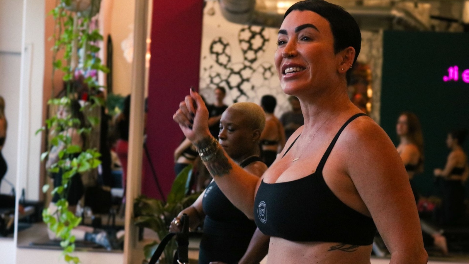 An Oak Cliff Pilates instructor cueing a class