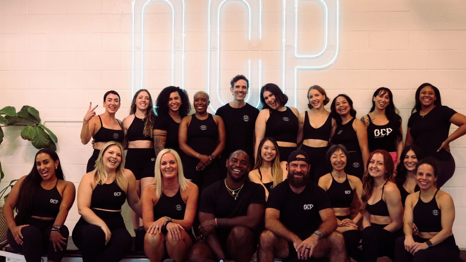 The Bishop Arts team under the OCP neon